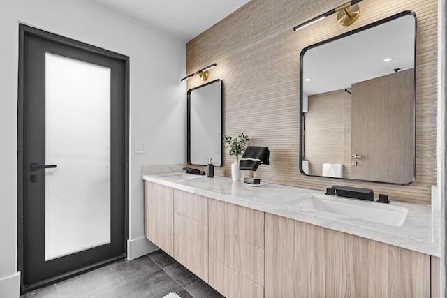 full bathroom with double vanity and a sink