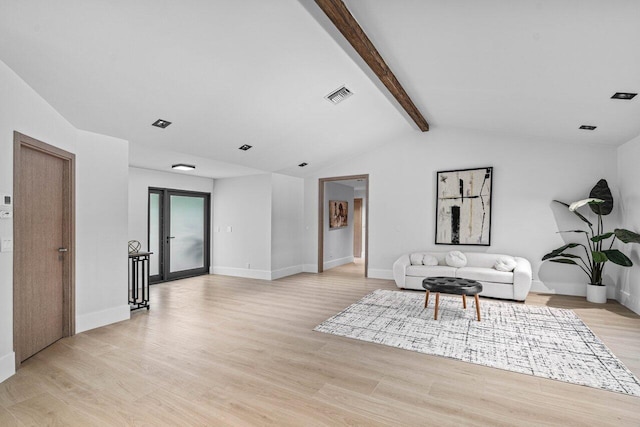 living area with light wood-style floors, visible vents, lofted ceiling with beams, and baseboards