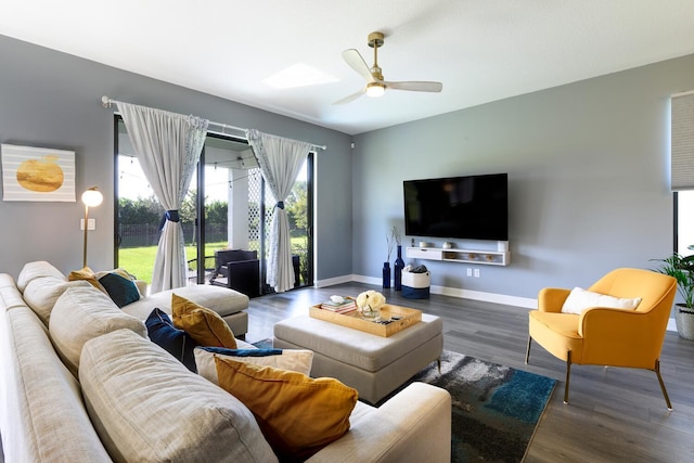 living room with dark hardwood / wood-style flooring and ceiling fan