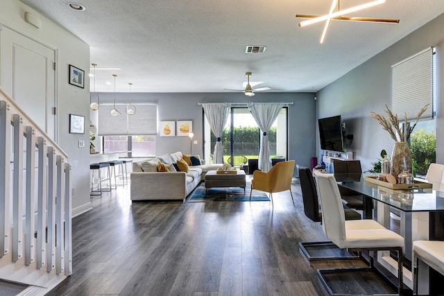 dining room featuring ceiling fan with notable chandelier and dark hardwood / wood-style floors