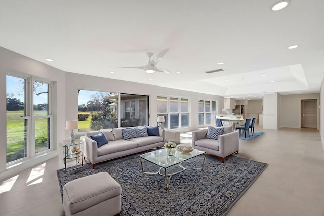 2371 SW Brookwood Ln, Palm City, FL 34990 - living room with a tray ceiling, ceiling fan, and recessed lighting