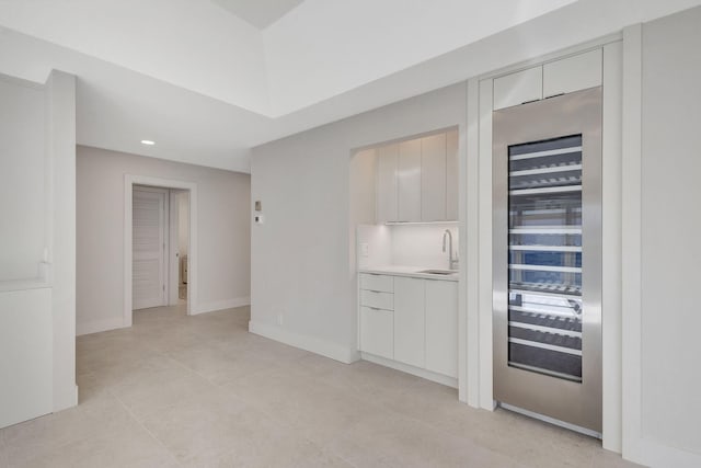 empty room with sink and beverage cooler