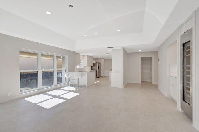 unfurnished living room featuring sink