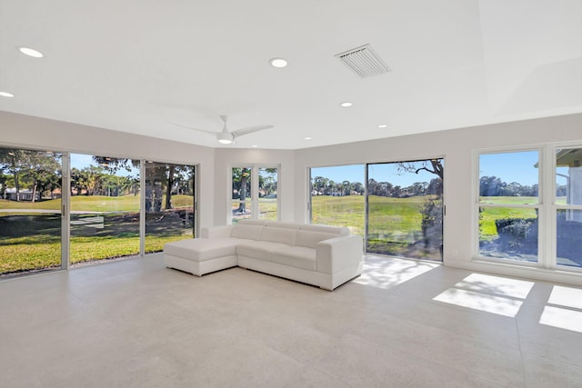 unfurnished sunroom featuring a wealth of natural light and ceiling fan