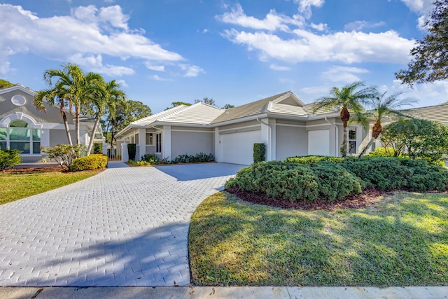 view of front of house featuring a garage and a front lawn