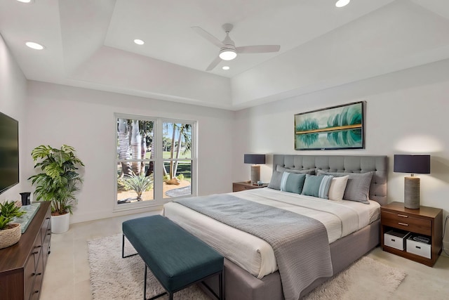 bedroom with ceiling fan and a tray ceiling