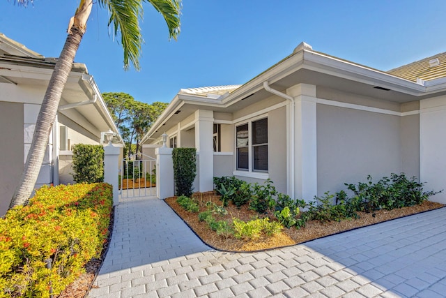 2371 SW Brookwood Ln, Palm City, FL 34990 - view of property exterior featuring a gate and stucco siding