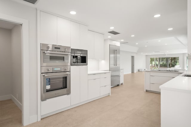 2371 SW Brookwood Ln, Palm City, FL 34990 - kitchen featuring stainless steel appliances, modern cabinets, recessed lighting, white cabinets, and light countertops