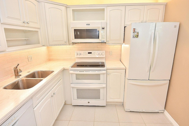 1225 NW 21st St Unit 3406, Stuart, FL 34994 - kitchen featuring white appliances, a sink, light tile patterned floors, and backsplash