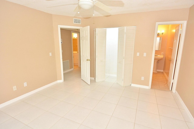 1225 NW 21st St Unit 3406, Stuart, FL 34994 - unfurnished bedroom with light tile patterned flooring, a ceiling fan, a closet, and baseboards