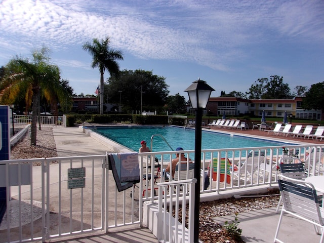 1225 NW 21st St Unit 3406, Stuart, FL 34994 - community pool featuring fence and a patio area