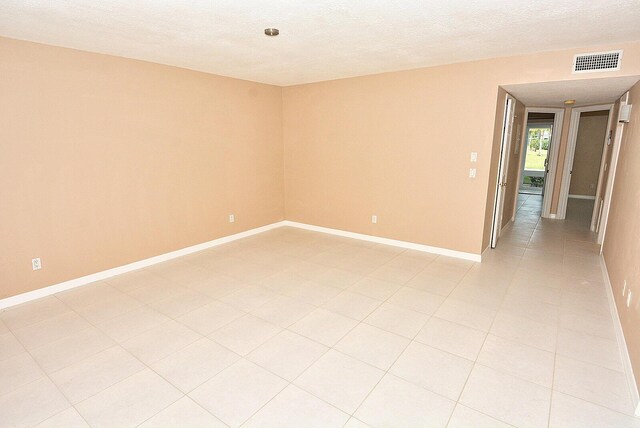 1225 NW 21st St Unit 3406, Stuart, FL 34994 - empty room featuring a textured ceiling and baseboards