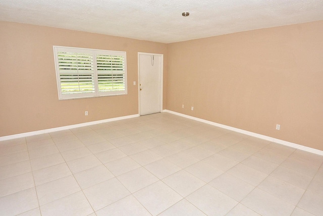 1225 NW 21st St Unit 3406, Stuart, FL 34994 - spare room with baseboards and a textured ceiling