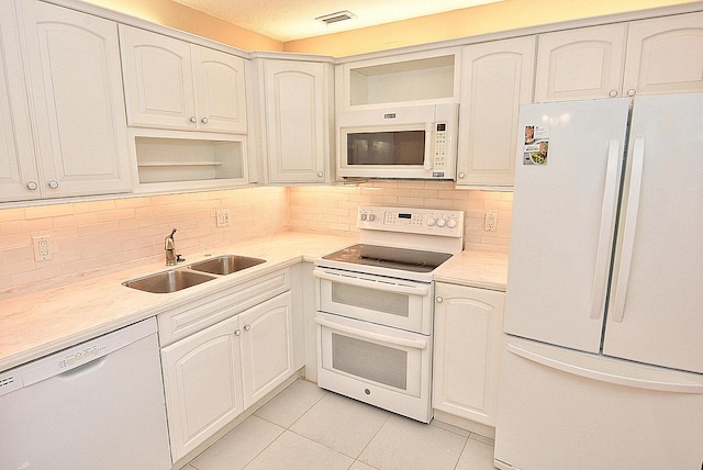 1225 NW 21st St Unit 3406, Stuart, FL 34994 - kitchen with white appliances, a sink, open shelves, light tile patterned floors, and backsplash