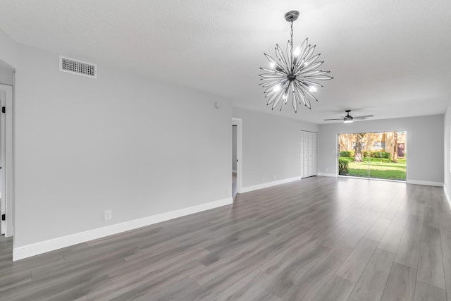 unfurnished living room with hardwood / wood-style floors and ceiling fan with notable chandelier