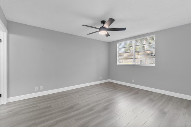 unfurnished room featuring ceiling fan and light wood-type flooring