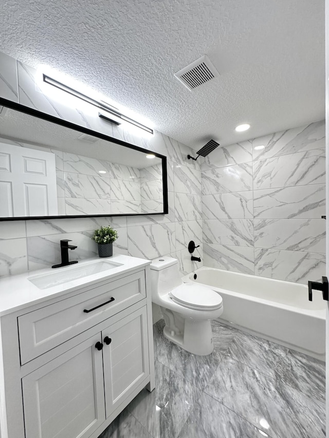 full bathroom with vanity, a textured ceiling, toilet, and tub / shower combination