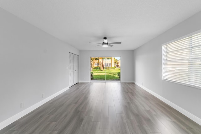 spare room featuring ceiling fan and dark hardwood / wood-style flooring