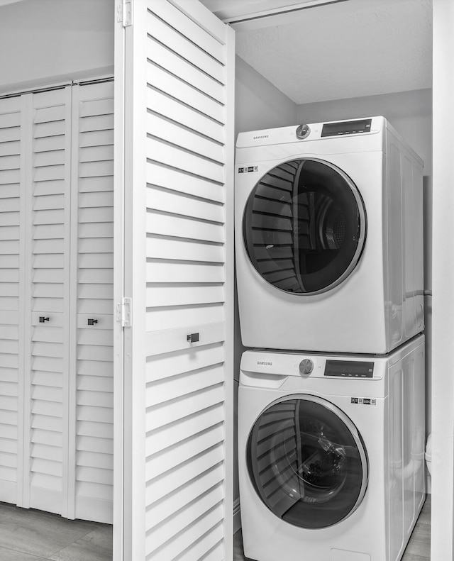 laundry room with stacked washer and dryer