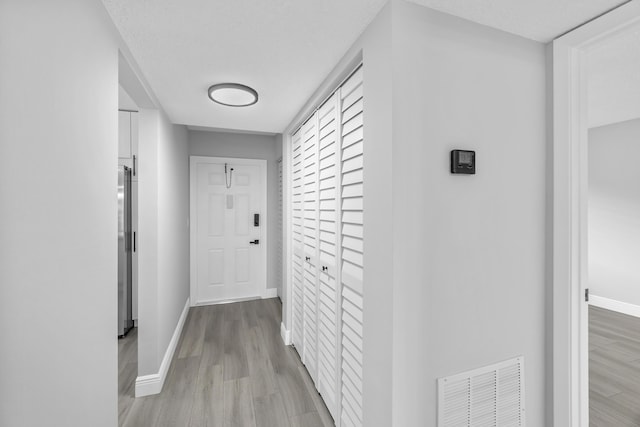 hallway with light wood-type flooring