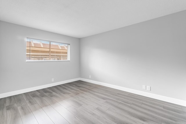 spare room featuring light wood-type flooring