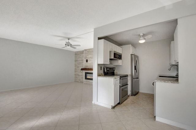 kitchen featuring white cabinetry, sink, ceiling fan, and stainless steel appliances