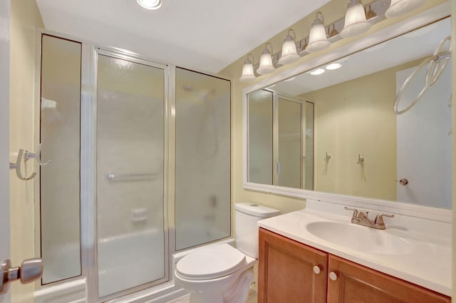 full bathroom with vanity, toilet, and combined bath / shower with glass door