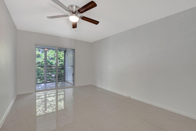 empty room featuring ceiling fan and light tile patterned floors