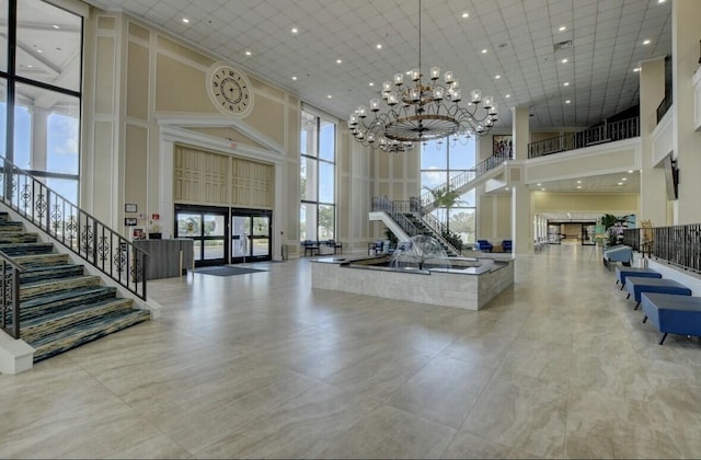 4064 Newport Q Unit 4064, Deerfield Beach, FL 33442 - building lobby featuring a high ceiling, stairs, and recessed lighting