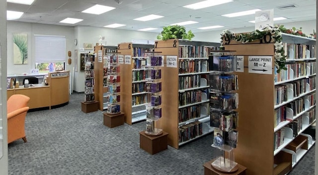 4064 Newport Q Unit 4064, Deerfield Beach, FL 33442 - misc room with wall of books, a paneled ceiling, and carpet floors