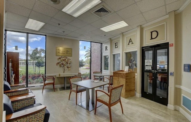 4064 Newport Q Unit 4064, Deerfield Beach, FL 33442 - dining space with a wall of windows, a paneled ceiling, french doors, and light tile patterned floors