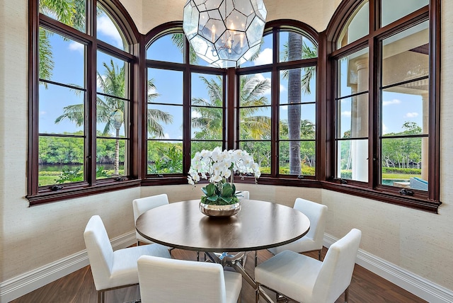 dining area with an inviting chandelier and dark hardwood / wood-style flooring