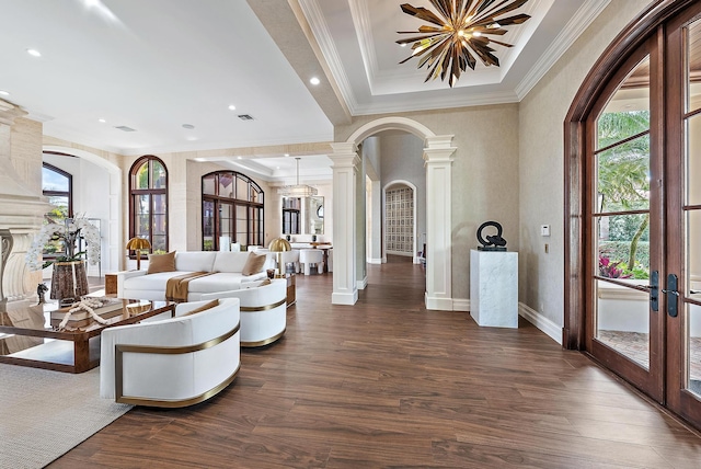 living room featuring decorative columns, dark hardwood / wood-style flooring, and french doors