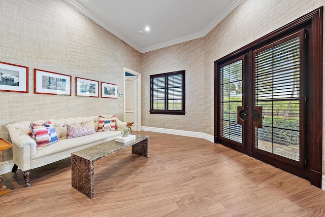 living room with crown molding, french doors, and light wood-type flooring