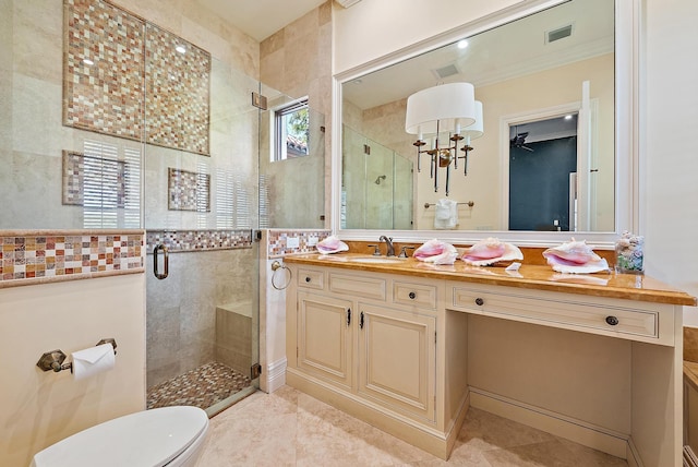 bathroom with tile patterned floors, toilet, ornamental molding, vanity, and a shower with door