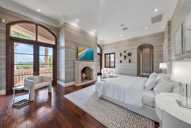 bedroom with ornamental molding, hardwood / wood-style floors, and french doors