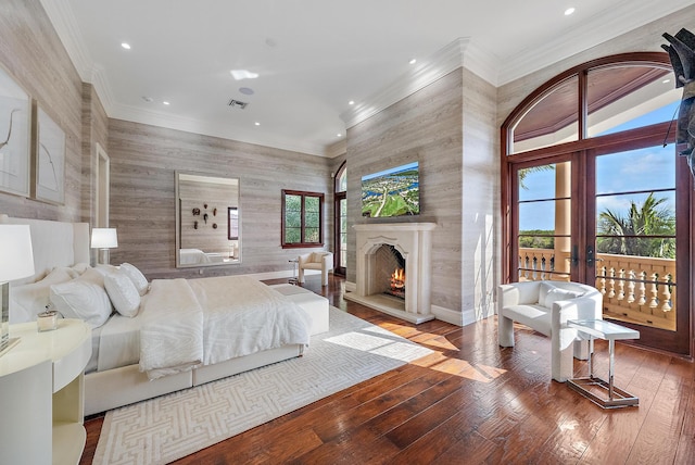 bedroom with crown molding, hardwood / wood-style floors, and french doors