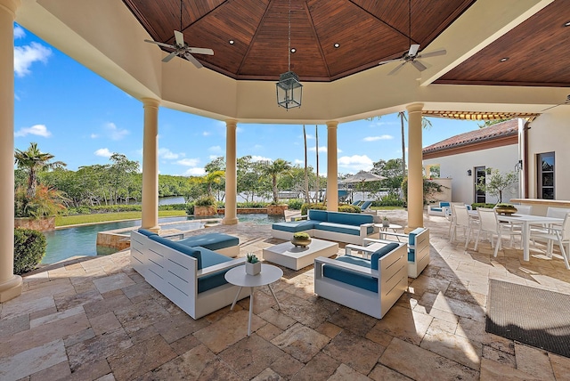 view of patio featuring a gazebo, an outdoor hangout area, ceiling fan, and a water view