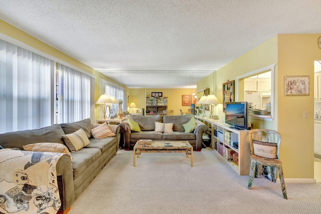 living room featuring a textured ceiling and light colored carpet