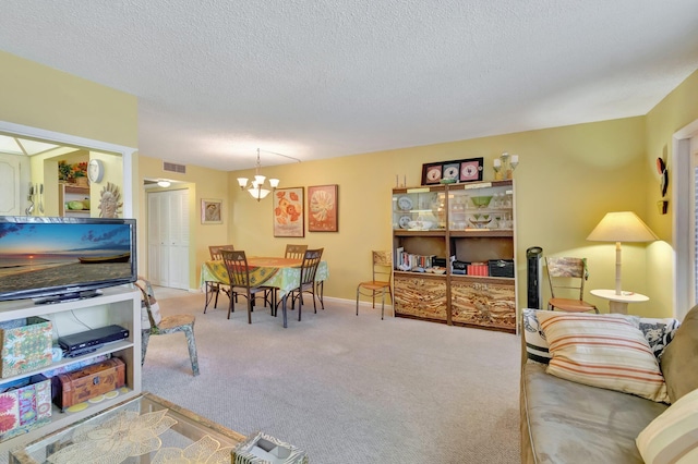 living room featuring carpet flooring, a textured ceiling, and a chandelier