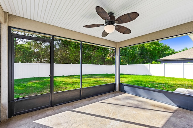 unfurnished sunroom with ceiling fan