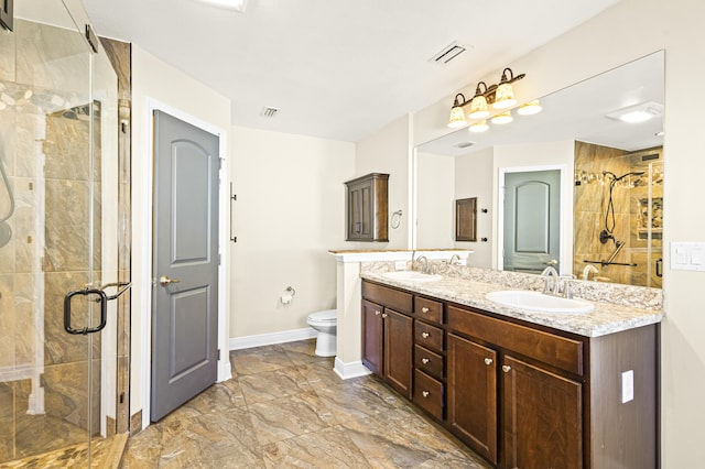 bathroom featuring vanity, an enclosed shower, and toilet