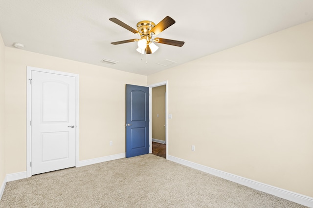 unfurnished bedroom with ceiling fan and light carpet