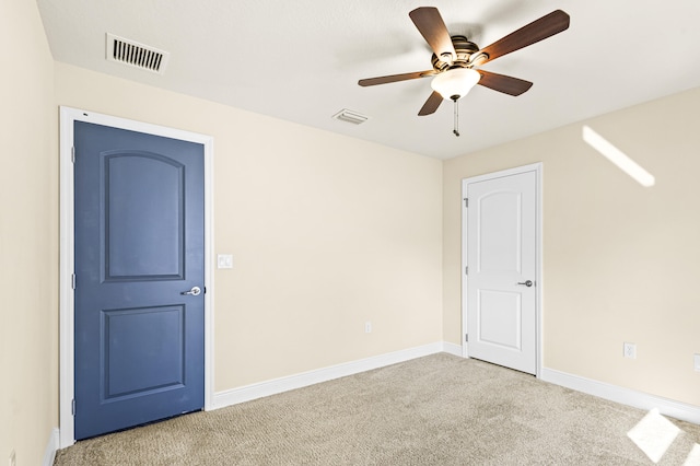 carpeted empty room with ceiling fan