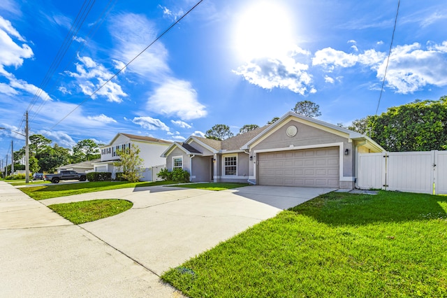 view of front of home featuring a front yard and a garage