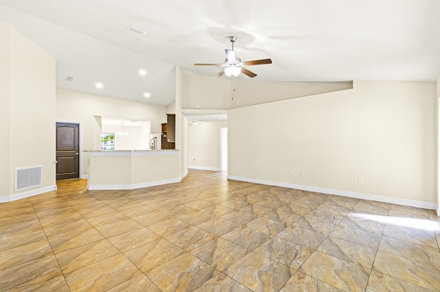 unfurnished living room featuring ceiling fan and vaulted ceiling