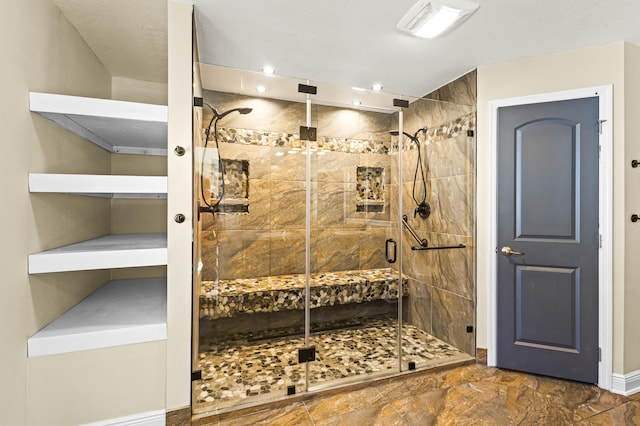 bathroom featuring a shower with door