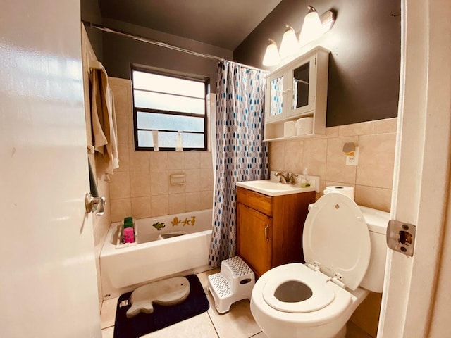 full bathroom featuring shower / bath combination with curtain, vanity, tile walls, tile patterned flooring, and toilet