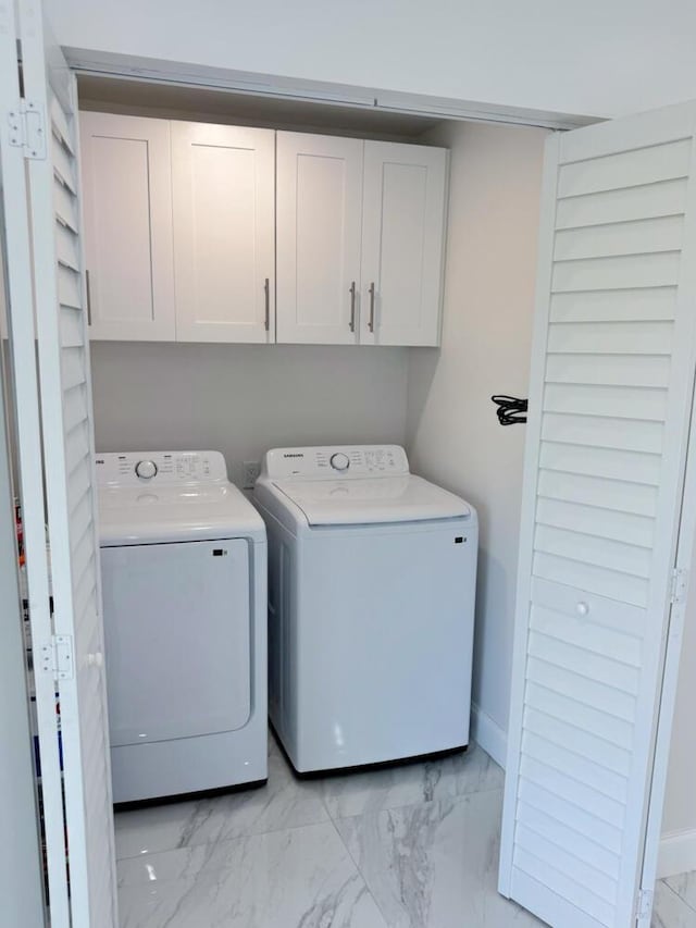 washroom with cabinets and separate washer and dryer