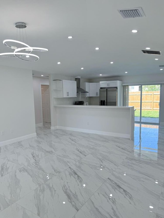 unfurnished living room with an inviting chandelier